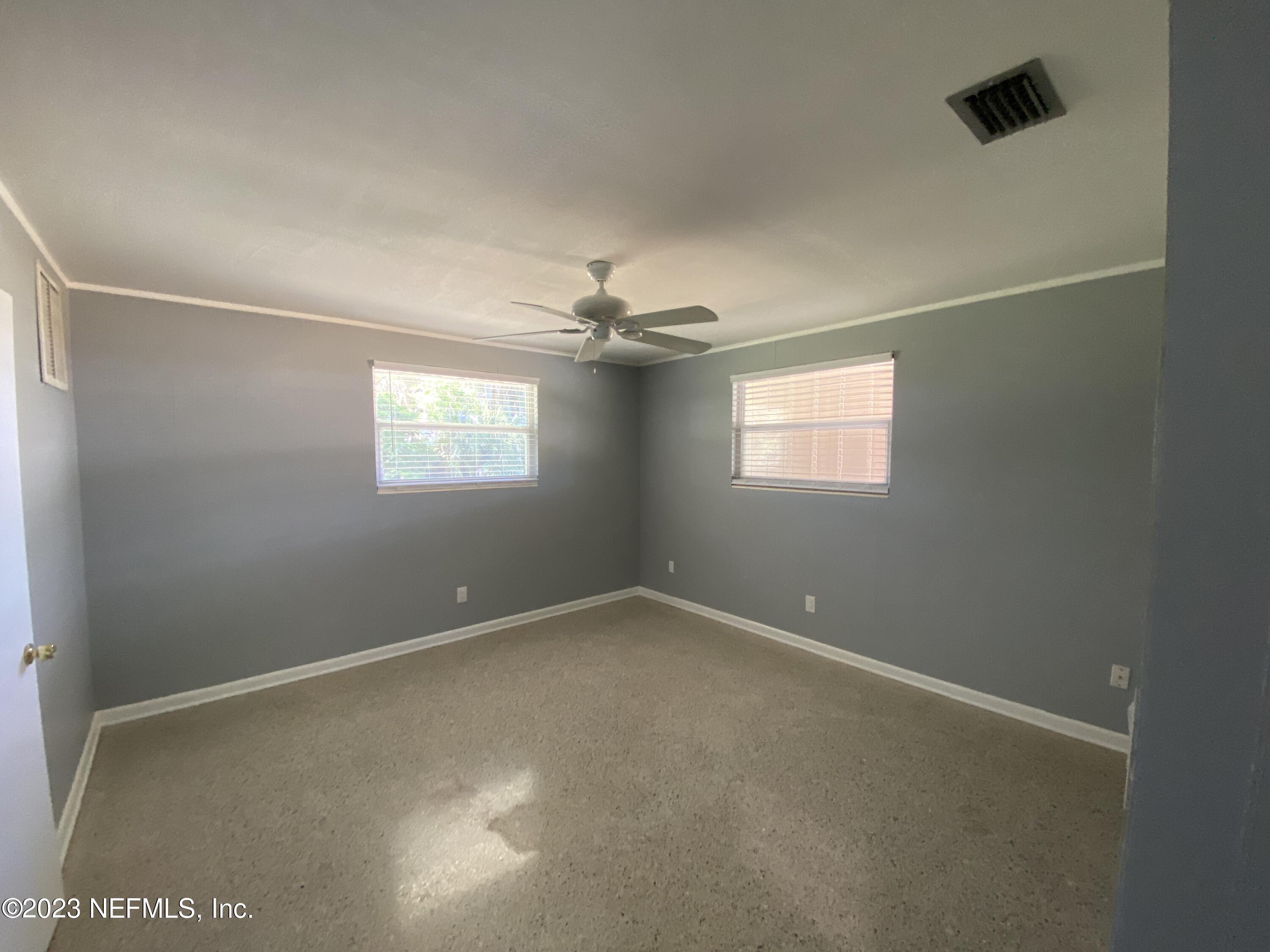 102 St Elmo Road Green Cove Springs, FL 32043 - Photo 11 of 15 an empty room with windows and fan