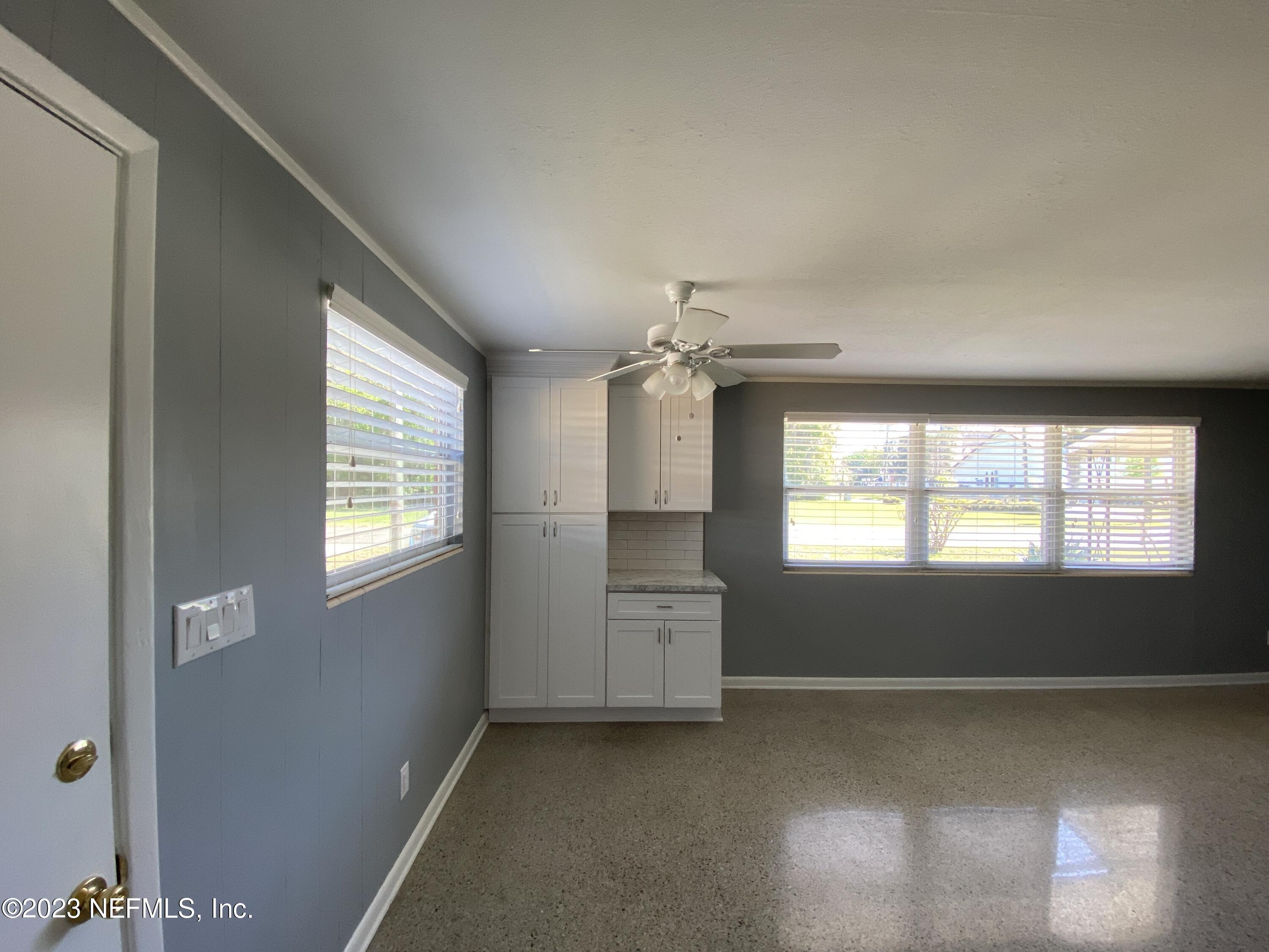 102 St Elmo Road Green Cove Springs, FL 32043 - Photo 12 of 15 an empty room with windows and chandelier fan