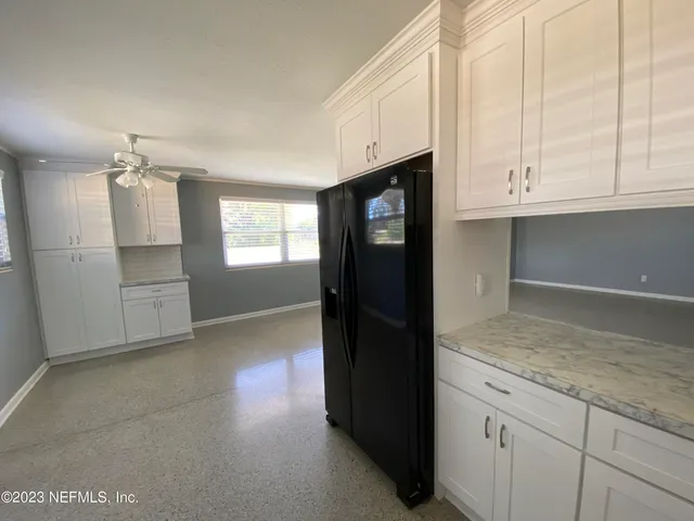 a kitchen with stainless steel appliances kitchen island granite countertop a refrigerator and a stove