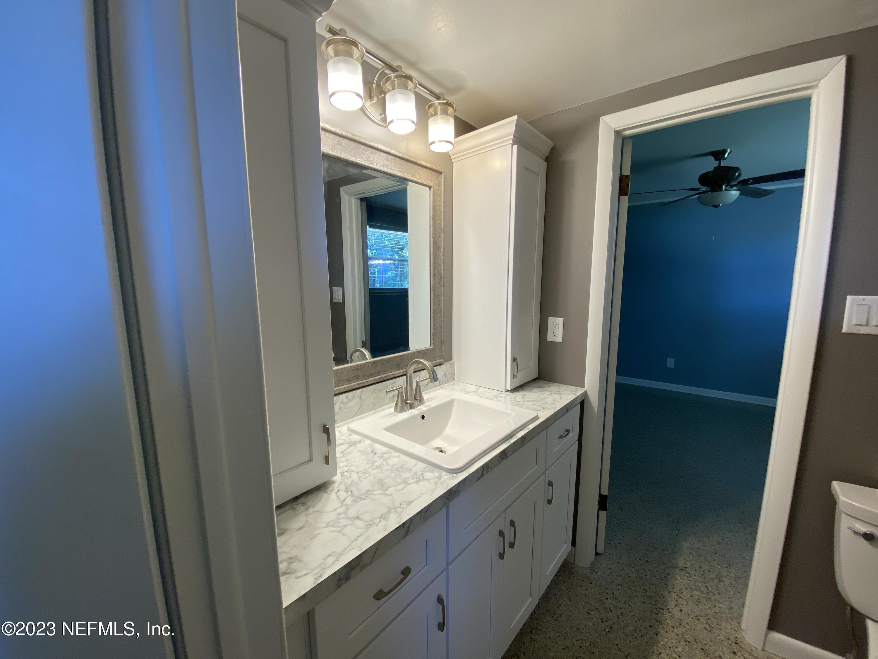102 St Elmo Road Green Cove Springs, FL 32043 - Photo 7 of 15 a bathroom with a granite countertop sink and a mirror