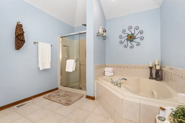 a bathroom with a tub and a shower