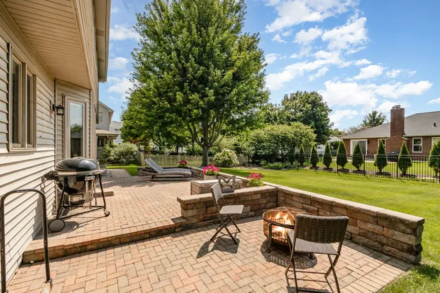 a view of a patio with a table and chairs