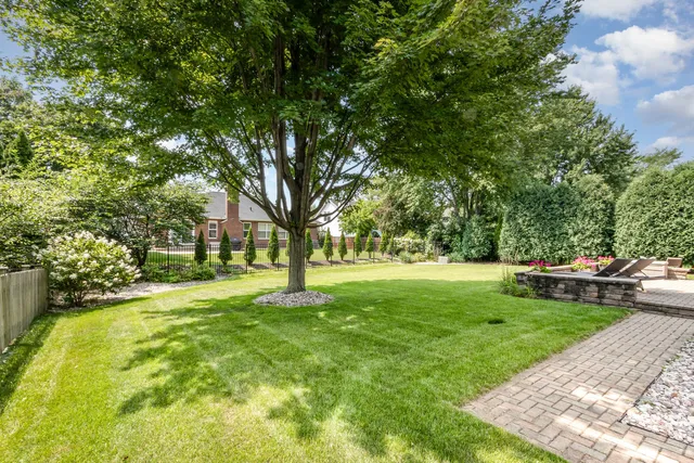 a view of a yard with a house and large trees