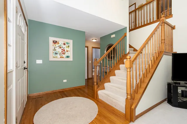 a view of entryway and hall with wooden floor