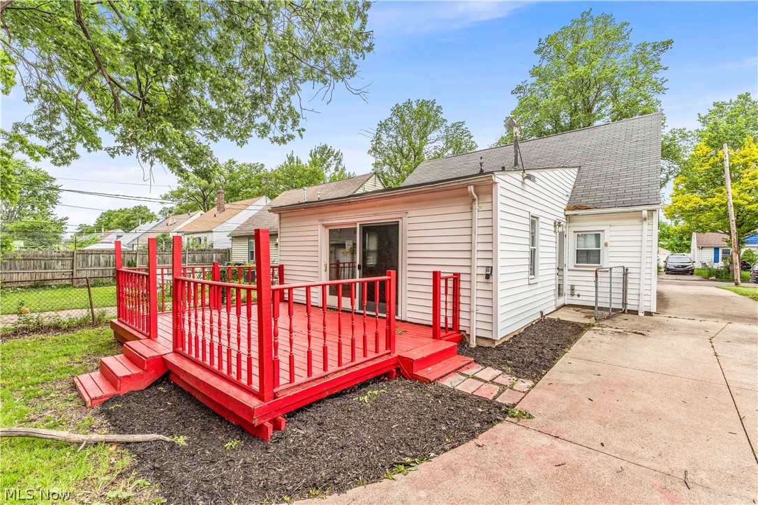 18517 Homeway Road Cleveland, OH 44135 - Photo 29 of 29 Bright red multi-level deck with baluster railings and steps providing access to the grassy yard
