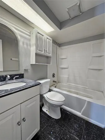 a bathroom with a sink toilet vanity and tub