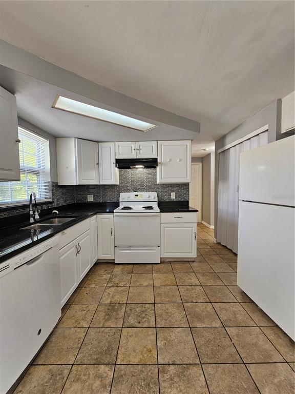 3029 Kilburn Road Holiday, FL 34691 - Photo 7 of 19 a kitchen with a sink a stove a refrigerator and cabinets