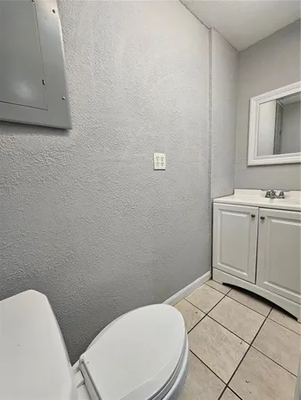 a white toilet sitting next to a bathroom sink