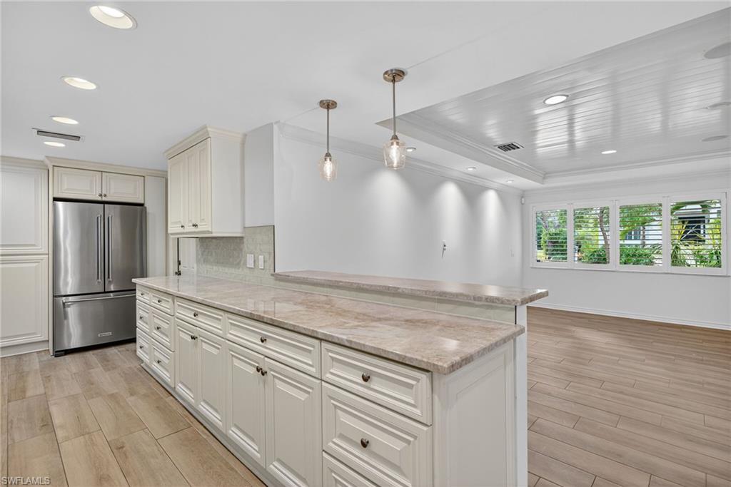 1135 7th Street South Naples, FL 34102 - Photo 17 of 35 a kitchen with a stove a refrigerator and a sink