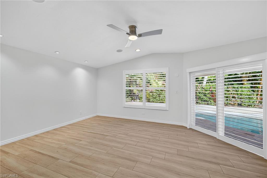 1135 7th Street South Naples, FL 34102 - Photo 18 of 35 wooden floor in an empty room with a window