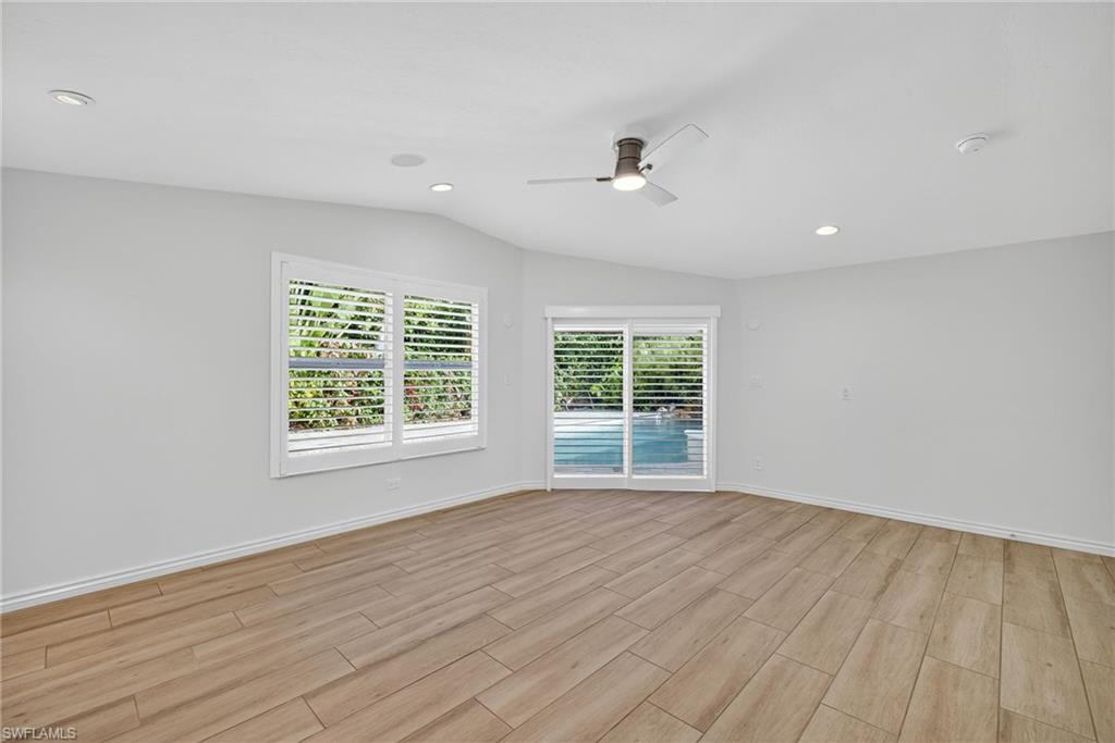 1135 7th Street South Naples, FL 34102 - Photo 19 of 35 a view of an empty room with wooden floor and a window