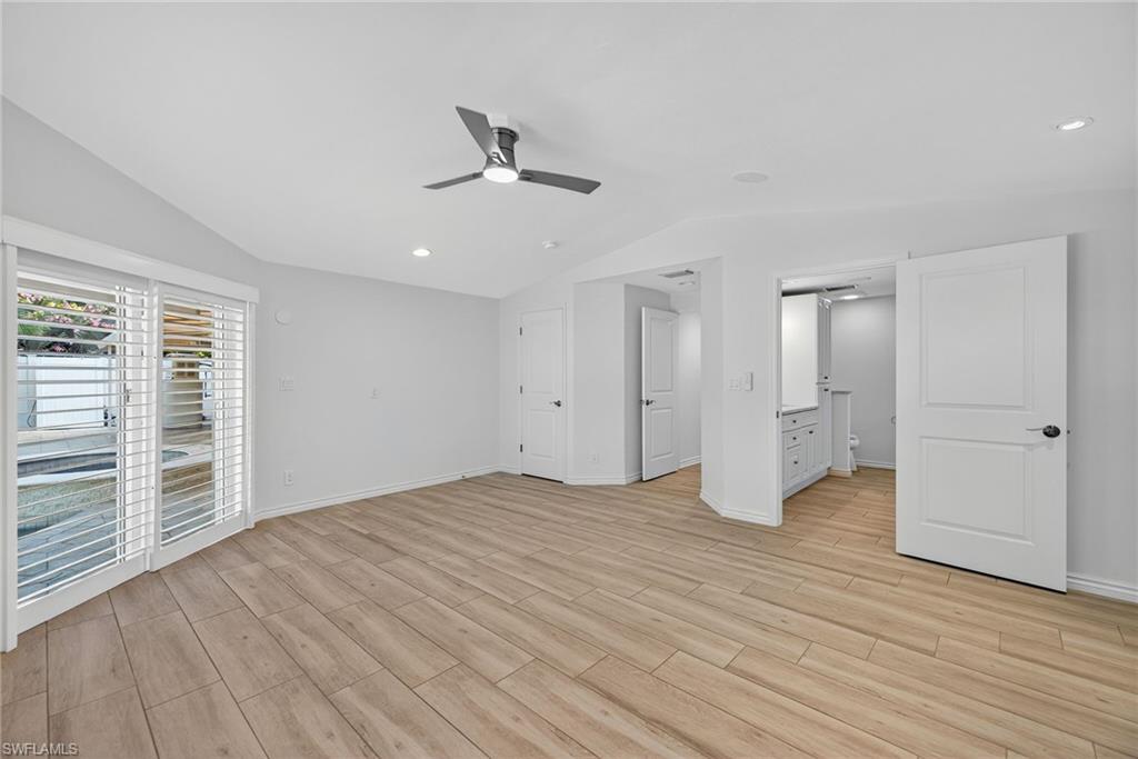 1135 7th Street South Naples, FL 34102 - Photo 20 of 35 wooden floor in an empty room with a window