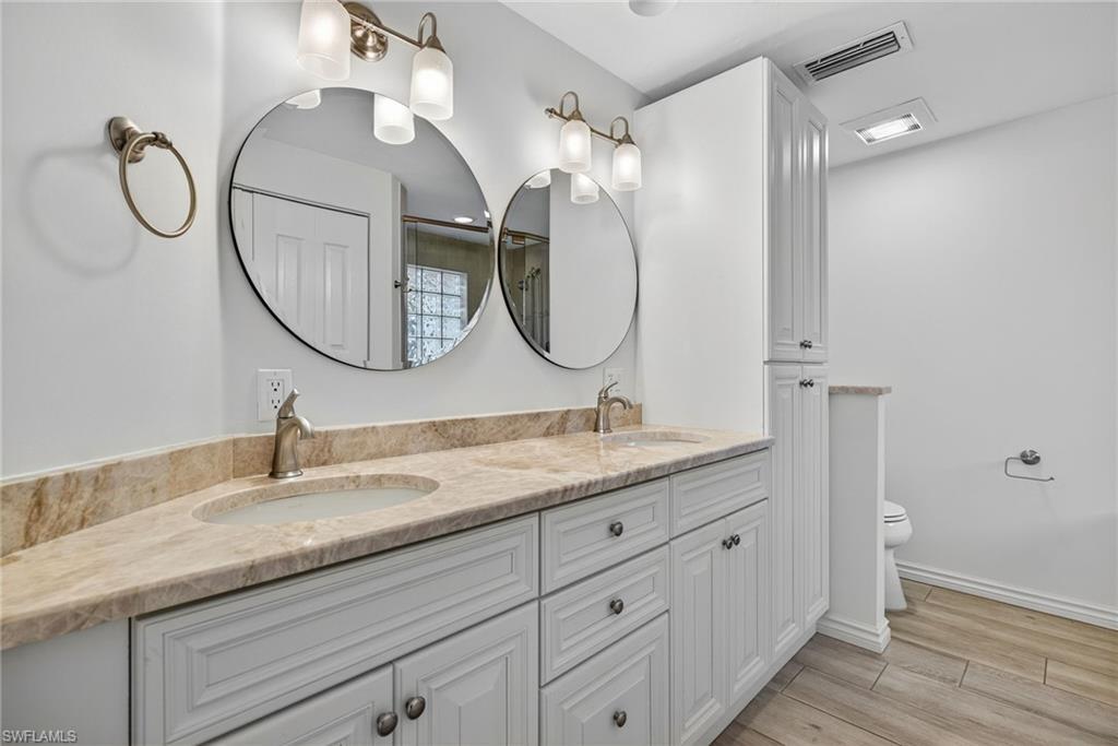 1135 7th Street South Naples, FL 34102 - Photo 21 of 35 a bathroom with a granite countertop sink mirror and vanity