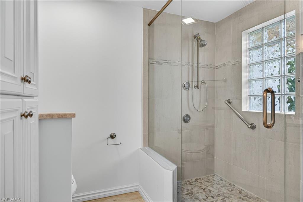 1135 7th Street South Naples, FL 34102 - Photo 22 of 35 a bathroom with a glass shower door