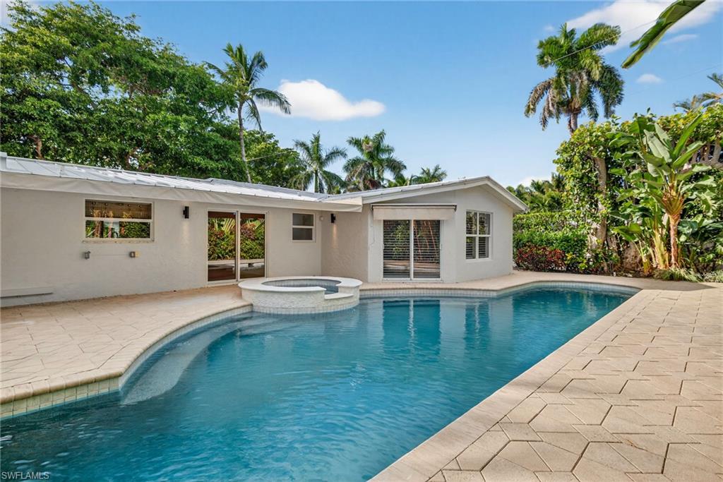 1135 7th Street South Naples, FL 34102 - Photo 32 of 35 a view of a house with pool and a yard
