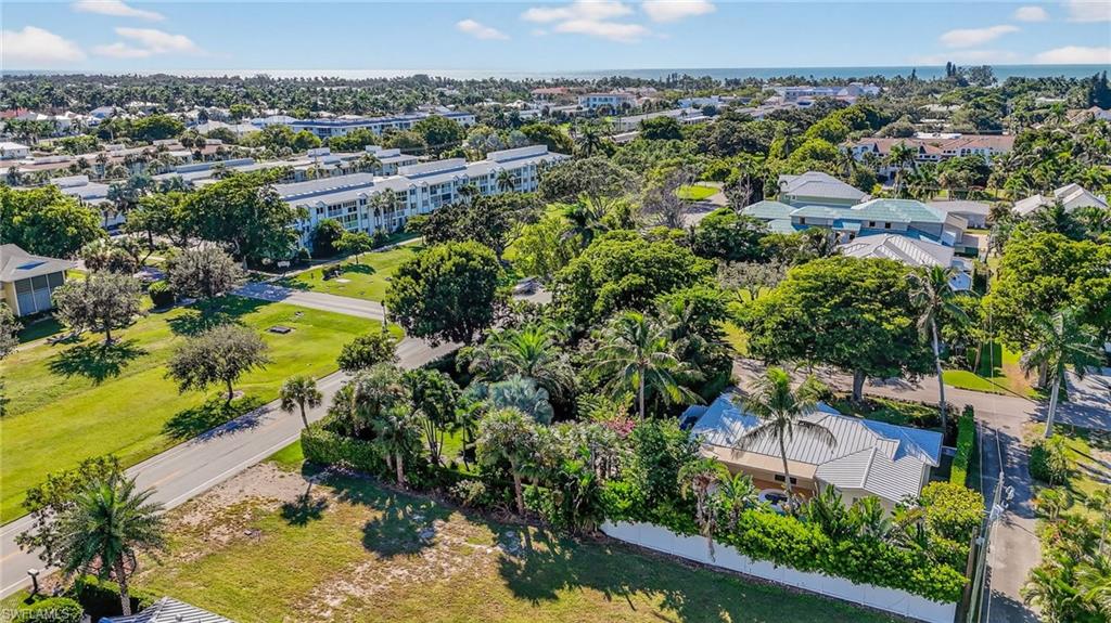 1135 7th Street South Naples, FL 34102 - Photo 33 of 35 an aerial view of a residential houses with outdoor space and swimming pool