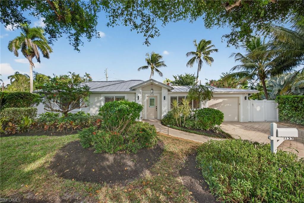 1135 7th Street South Naples, FL 34102 - Photo 7 of 35 a view of a garden with a fountain