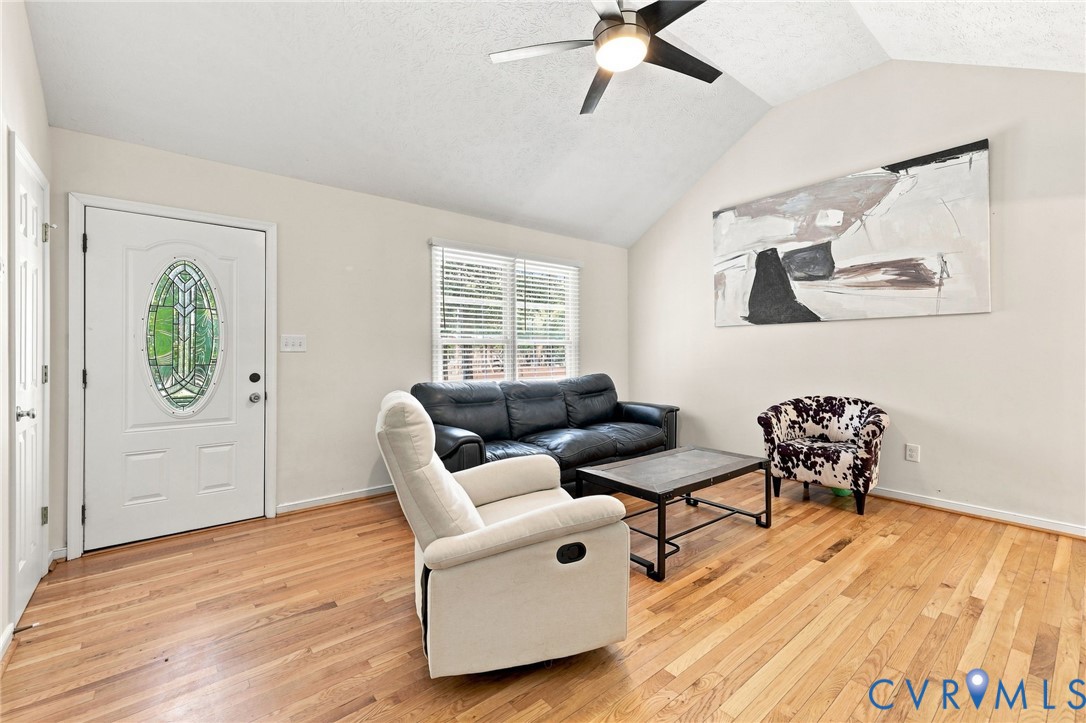 16753 Jolly Road Disputanta, VA 23842 - Photo 9 of 44 Vaulted ceiling with a ceiling fan, hardwood floor