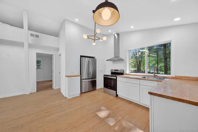 a kitchen with refrigerator and window