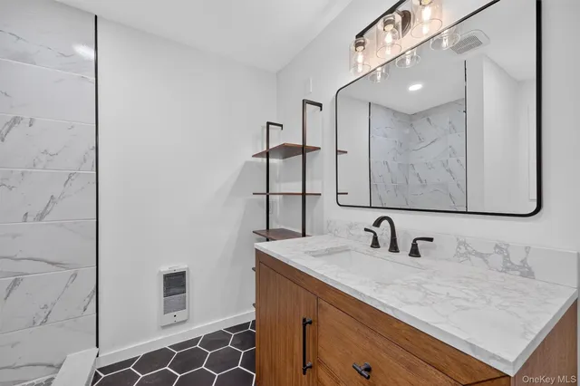 a bathroom with a sink and a mirror