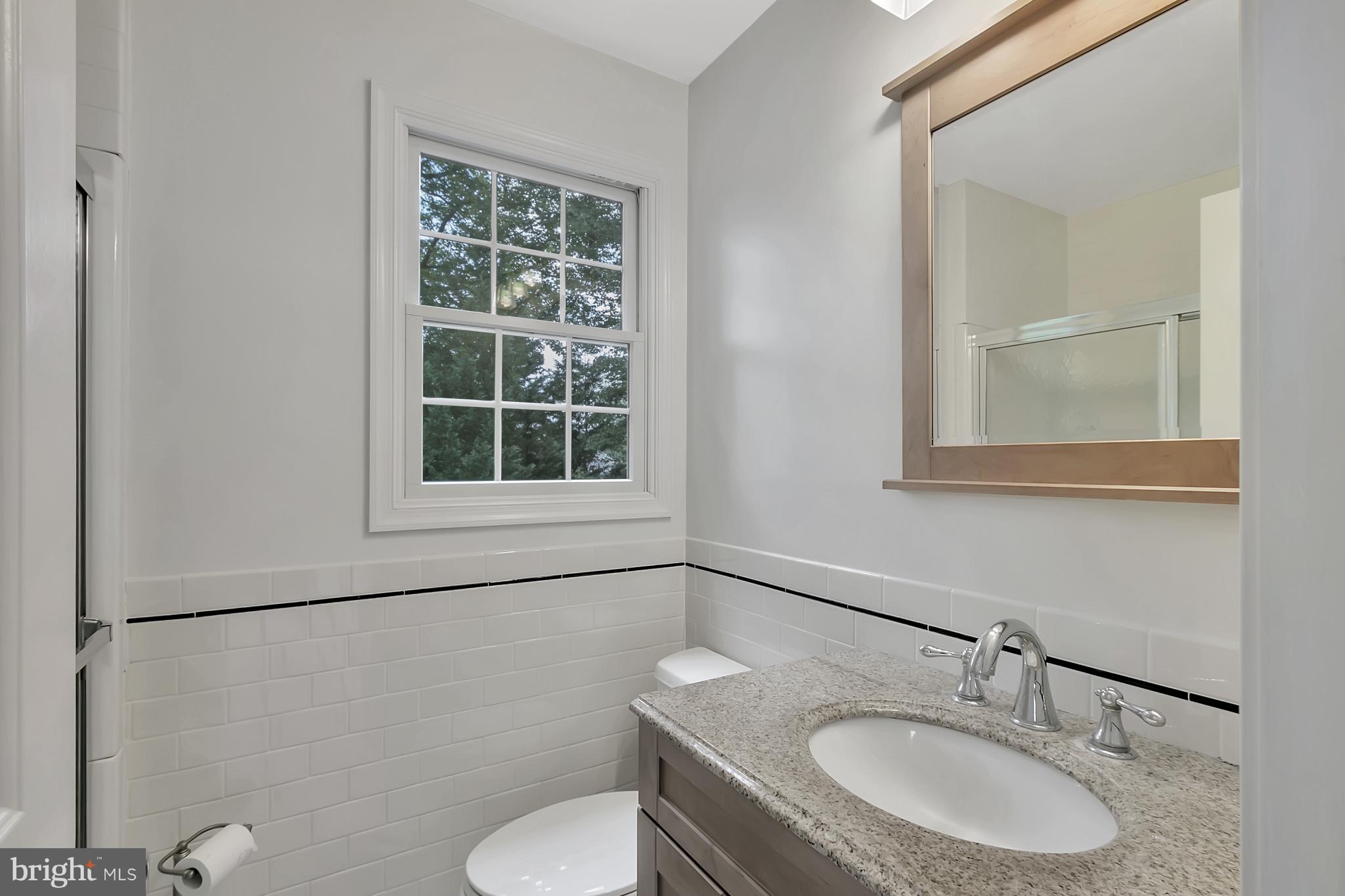 10 New Haven Drive Newark, DE 19713 - Photo 25 of 27 a bathroom with a sink toilet a mirror and shower