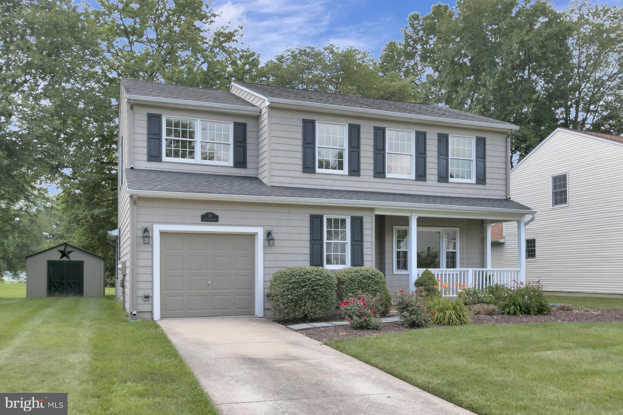 10 New Haven Drive Newark, DE 19713 - Photo 4 of 27 a front view of a house with a yard and garage