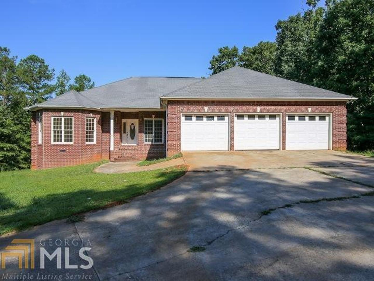 2054 Cleveland Road Bogart, GA 30622 - Photo 1 of 1 a front view of a house with a yard and garage