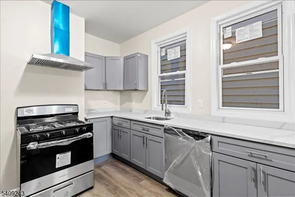 a kitchen with a sink stove and cabinets
