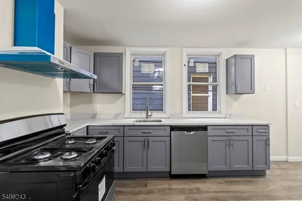 a kitchen with stainless steel appliances granite countertop a stove and a sink