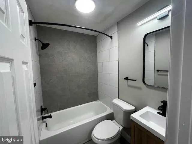 a bathroom with a toilet sink and shower