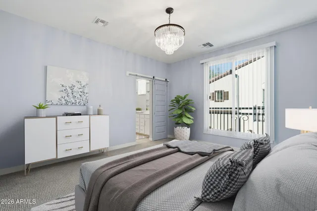 a bedroom with a bed and a window