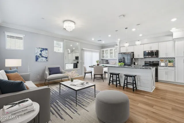 a living room with furniture and kitchen view