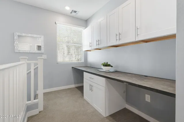 a kitchen with granite countertop white cabinets and white appliances