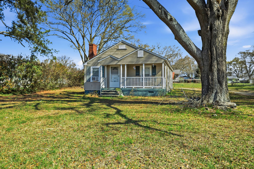 This charming residence offers a welcoming facade with a cozy porch and classic design.