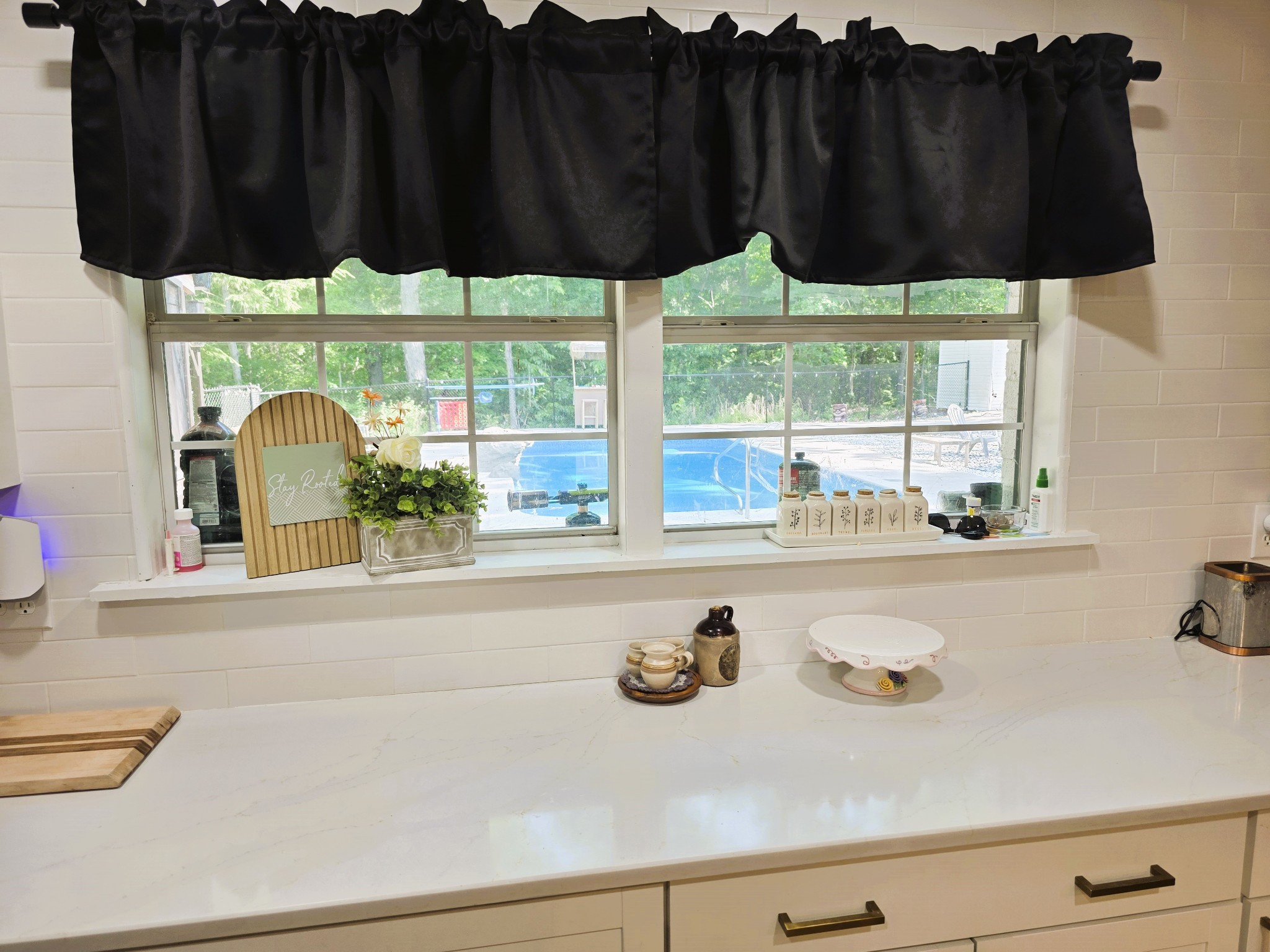 1975 Kelly Road Holladay, TN 38341 - Photo 37 of 95 a kitchen with a sink a window and a potted plant