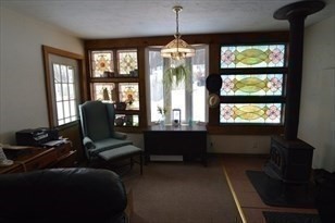 428 Putnam Hill Road Sutton, MA 01590 - Photo 23 of 42 a living room with furniture and a large window