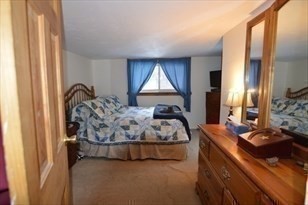 428 Putnam Hill Road Sutton, MA 01590 - Photo 26 of 42 a bed sitting in a room next to a window