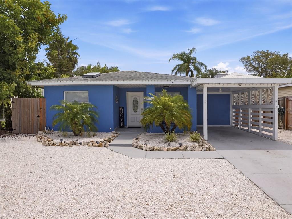 1207 1st Street Indian Rocks Beach, FL 33785 - Photo 4 of 60 a view of a house with a yard and potted plants
