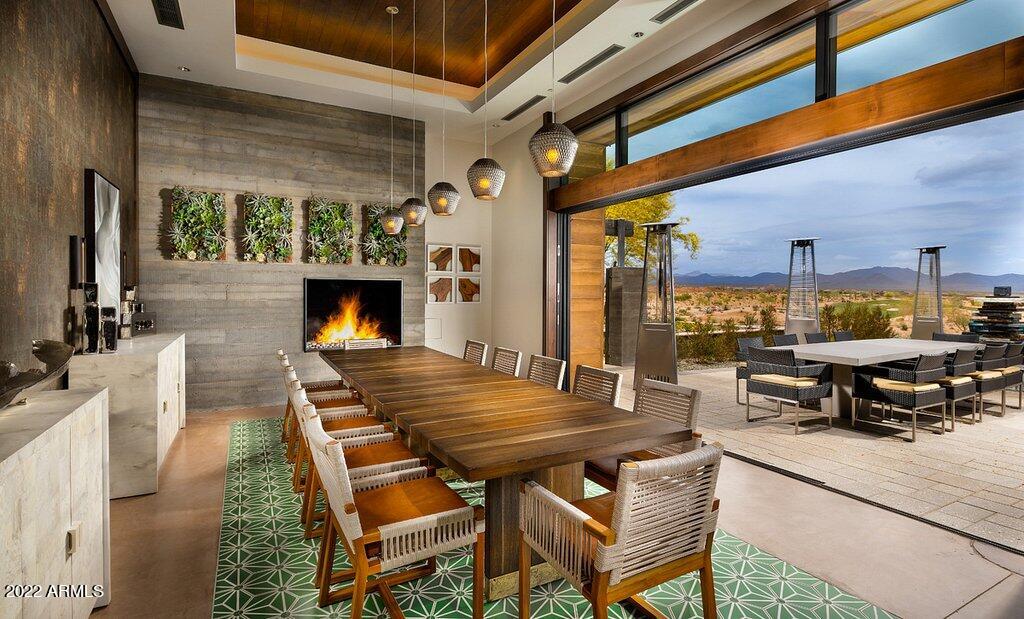 17860 East Cindercone Road Rio Verde, AZ 85263 - Photo 53 of 60 a view of a patio with table and chairs floor to ceiling window with wooden floor