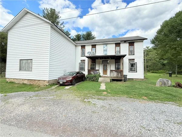 a view of a yard in front view of a house
