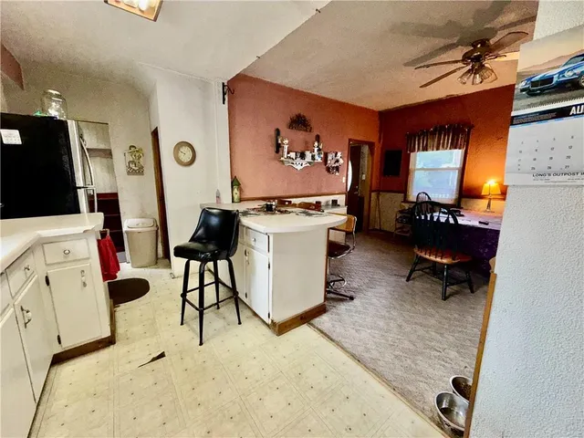 a room with furniture a rug and white walls