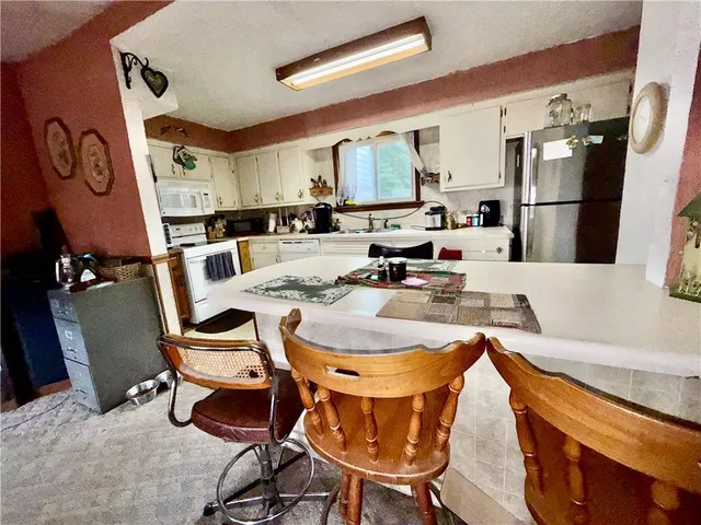 a dining room with furniture and a large window