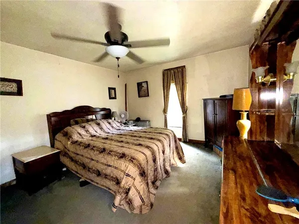 a bedroom with bed and a chandelier