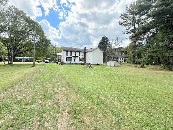 a view of a big yard with a house