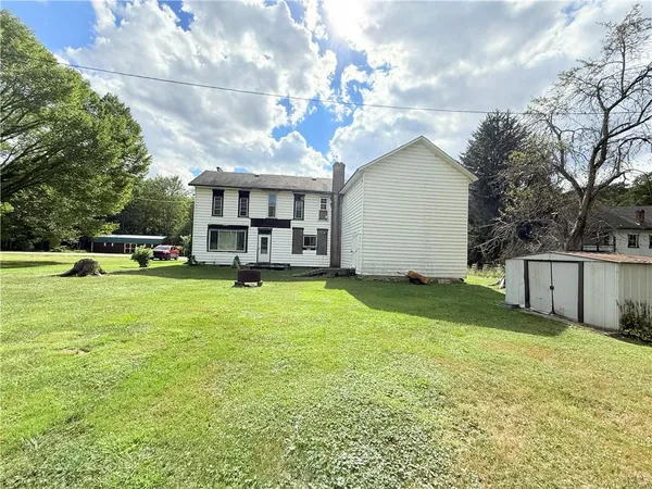 a view of a house with a backyard