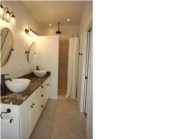 128 Marlin Street Santa Rosa Beach, FL 32459 - Photo 15 of 21 a bathroom with a granite countertop sink a mirror and shower