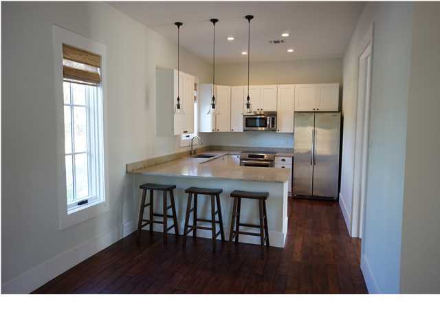 128 Marlin Street Santa Rosa Beach, FL 32459 - Photo 6 of 21 a kitchen with kitchen island a stove a refrigerator a sink and a cabinets