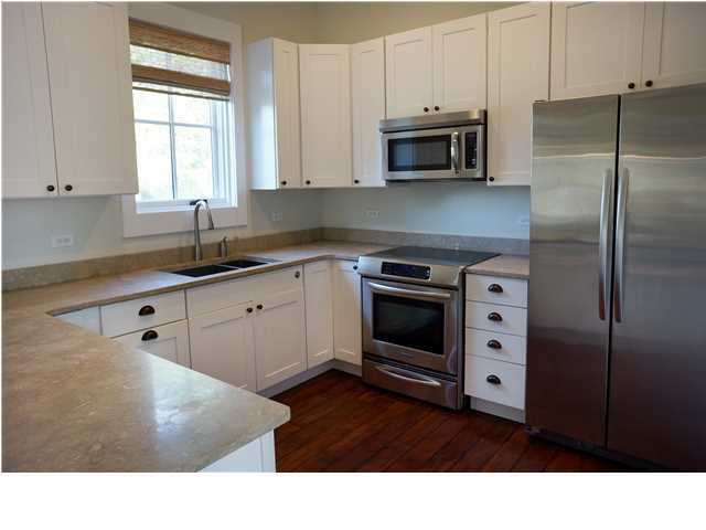 128 Marlin Street Santa Rosa Beach, FL 32459 - Photo 7 of 21 a kitchen with stainless steel appliances kitchen island granite countertop a stove a sink and a microwave