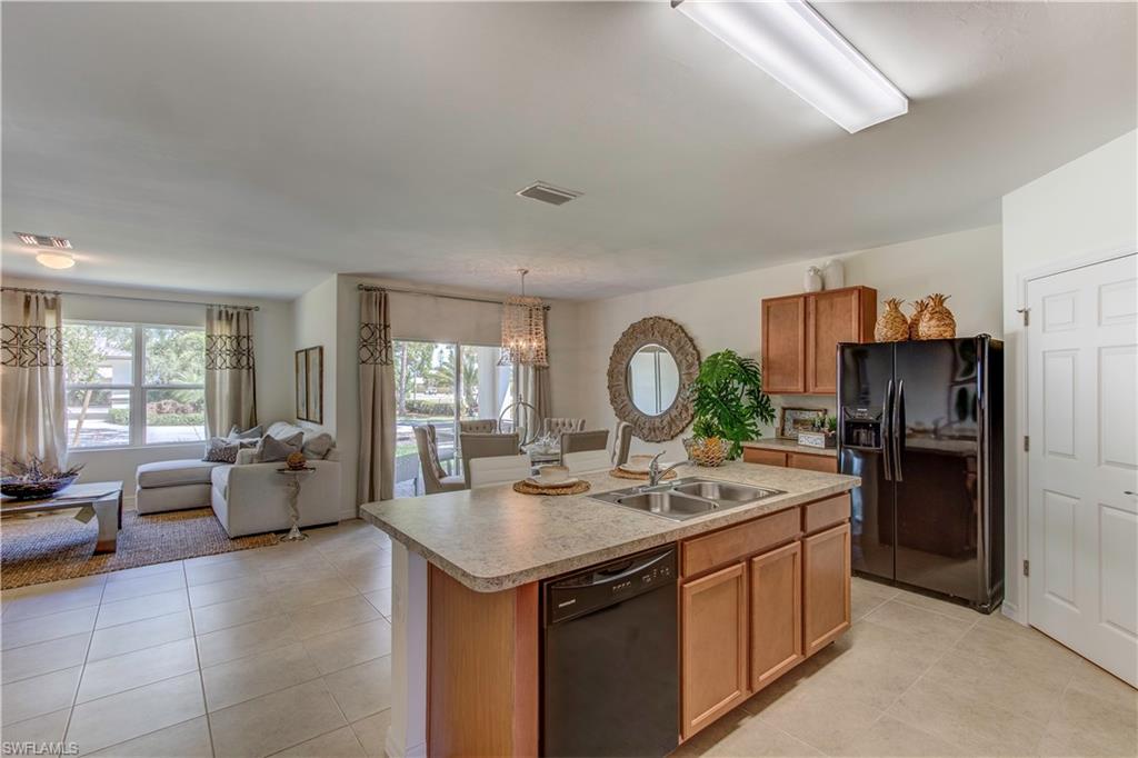 8165 Anhinga Road Fort Myers, FL 33967 - Photo 4 of 9 a open kitchen with stainless steel appliances granite countertop a sink stove and refrigerator