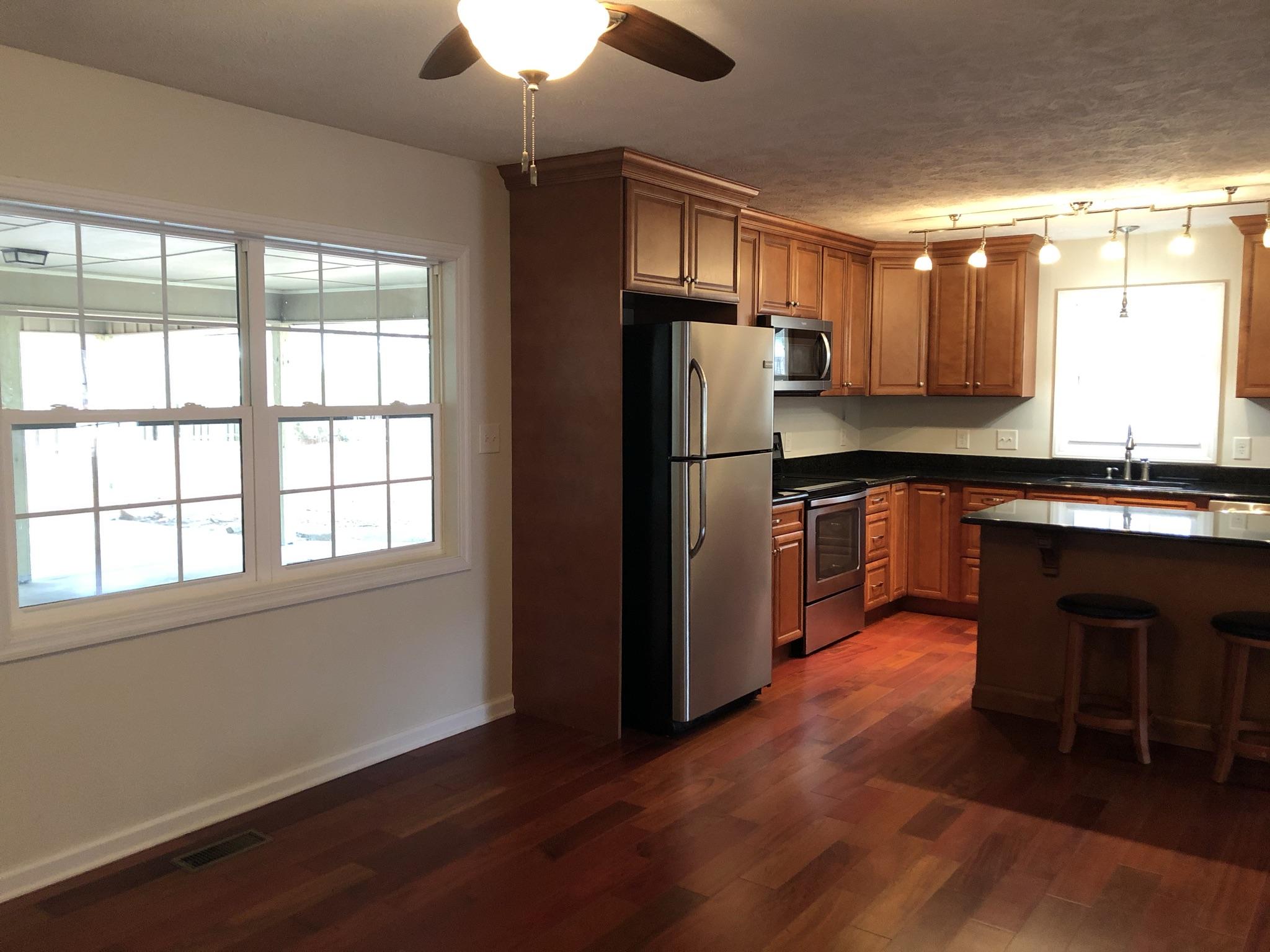 905 Robinwood Road Aberdeen, NC 28315 - Photo 16 of 42 large windows in the den keep it open as well as cozy